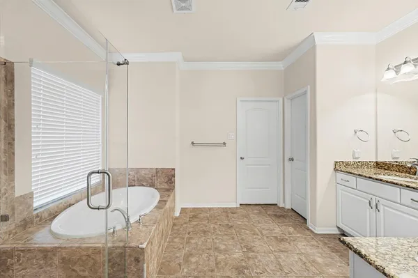 a spacious bathroom with a granite countertop sink and a mirror