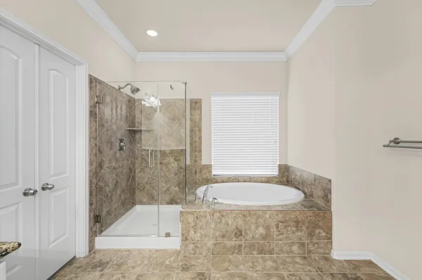 a bathroom with a granite countertop sink a mirror a bathtub and shower