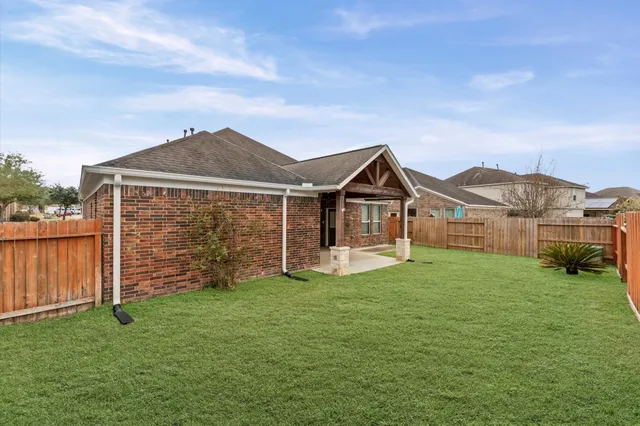 a front view of a house with a garden and yard