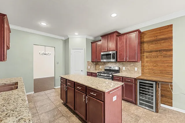 a kitchen with a stove sink and cabinets
