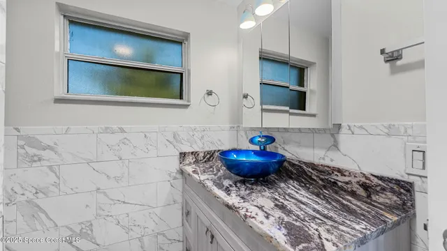a bathroom with a stove and a mirror