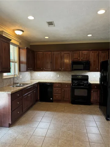 a kitchen with a refrigerator stove and cabinets