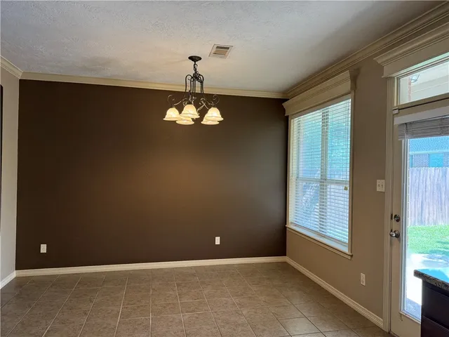 a view of a hallway with dining room and mirror