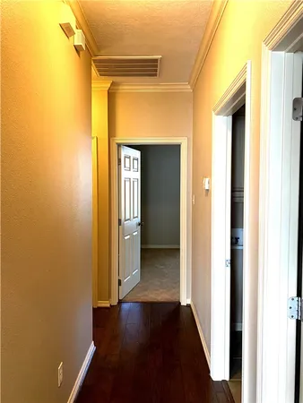 an empty room with a chandelier fan and windows