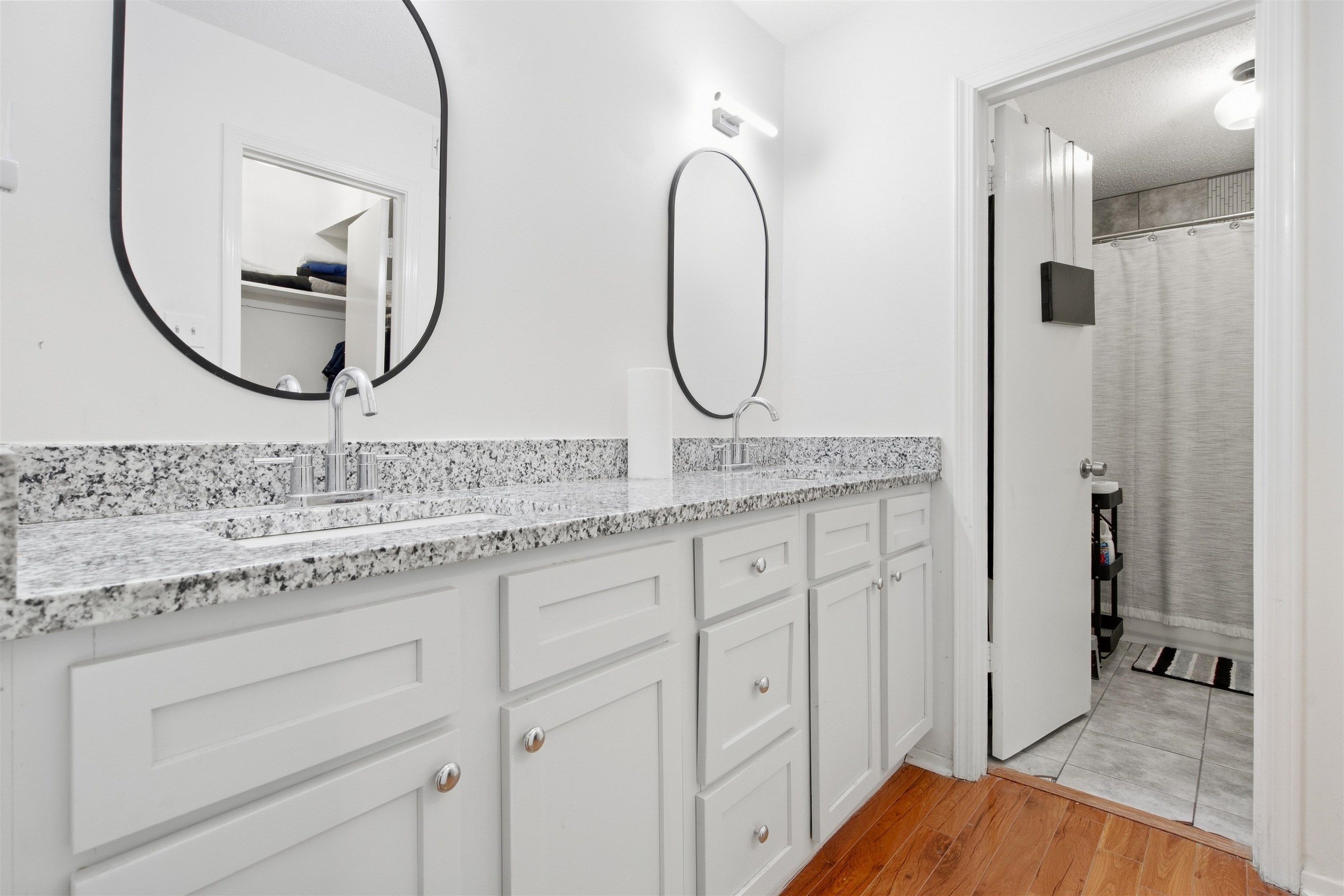 8367 Brownstone Lane, Unit 22 Cordova, TN 38016 - Photo 16 of 20 Double vanity with a speckled countertop, integrated sinks, white cabinetry, and wall-mounted lighting
