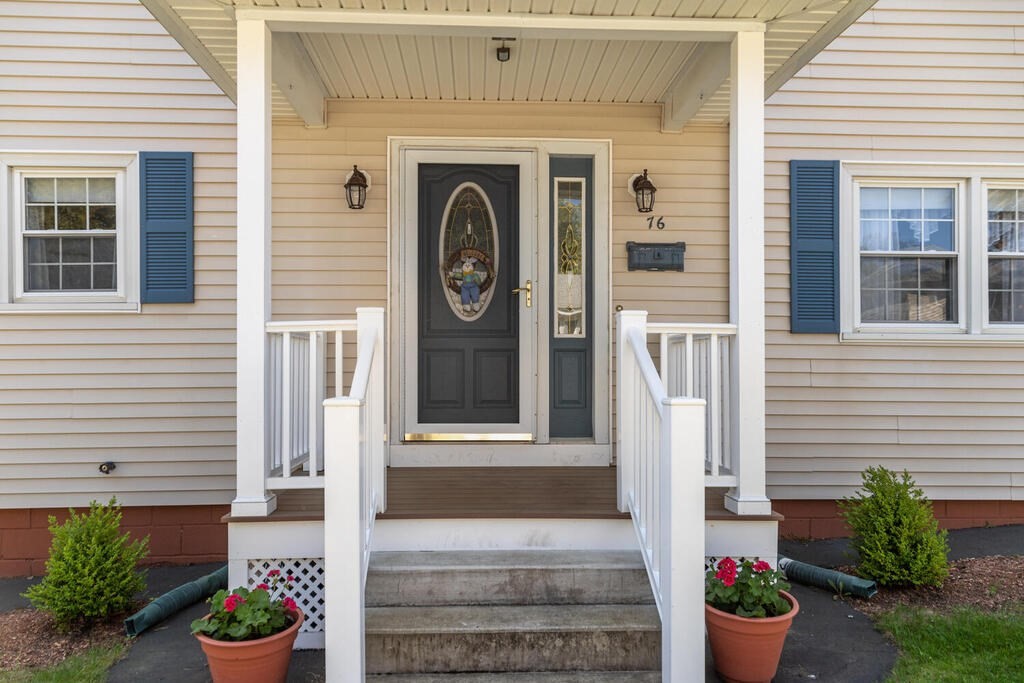 76 Hally Road Lowell, MA 01854 - Photo 4 of 36 a front view of a house with potted plants