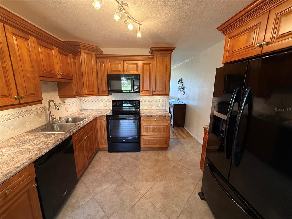 2460 Canadian Way, Unit 22 Clearwater, FL 33763 - Photo 11 of 42 a kitchen with a refrigerator sink and stove