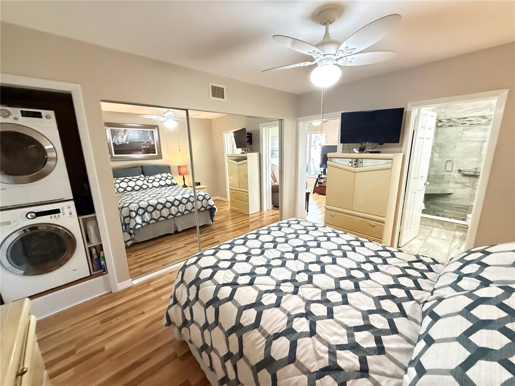 2460 Canadian Way, Unit 22 Clearwater, FL 33763 - Photo 19 of 42 a bedroom with a bed and a flat tv screen on dresser