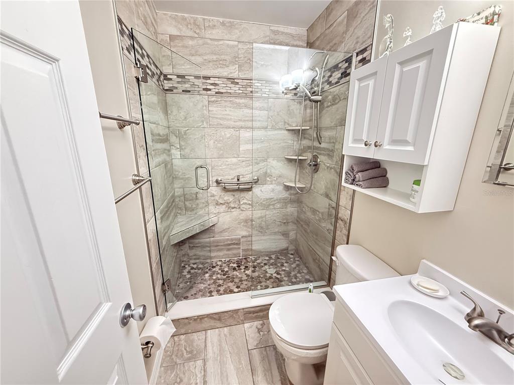 2460 Canadian Way, Unit 22 Clearwater, FL 33763 - Photo 20 of 42 a bathroom with a sink toilet and shower