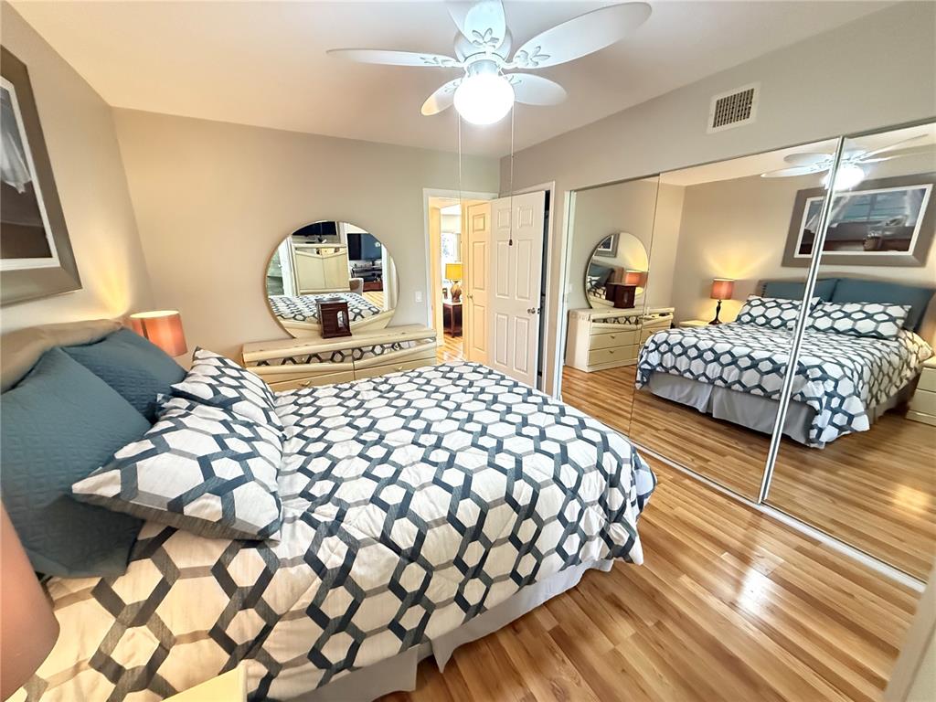 2460 Canadian Way, Unit 22 Clearwater, FL 33763 - Photo 23 of 42 a bedroom with a large bed and a chandelier