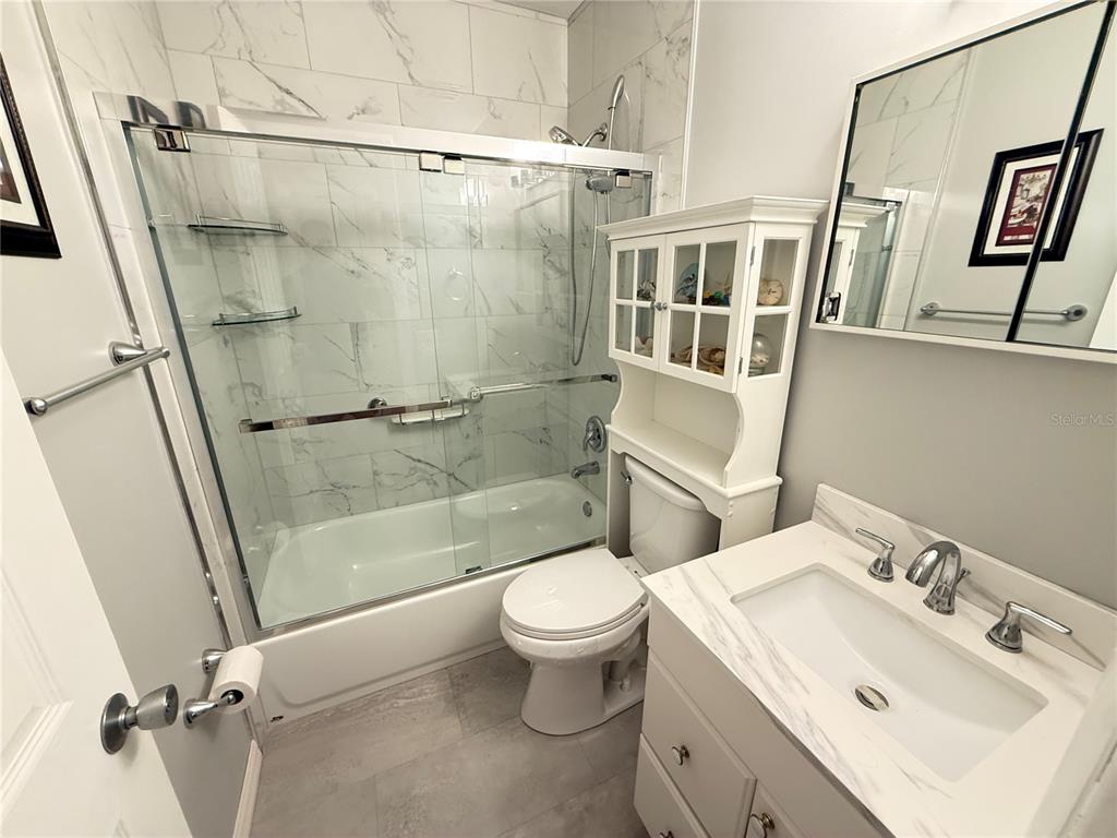 2460 Canadian Way, Unit 22 Clearwater, FL 33763 - Photo 24 of 42 a bathroom with a sink toilet and shower