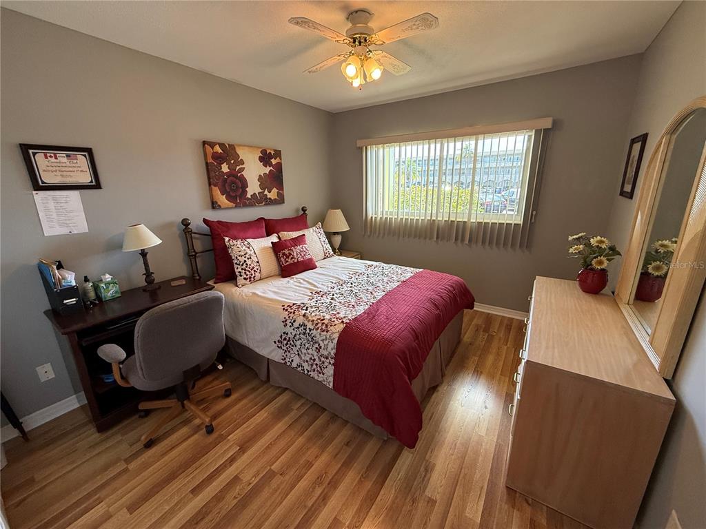 2460 Canadian Way, Unit 22 Clearwater, FL 33763 - Photo 26 of 42 a bedroom with a bed a window and dresser
