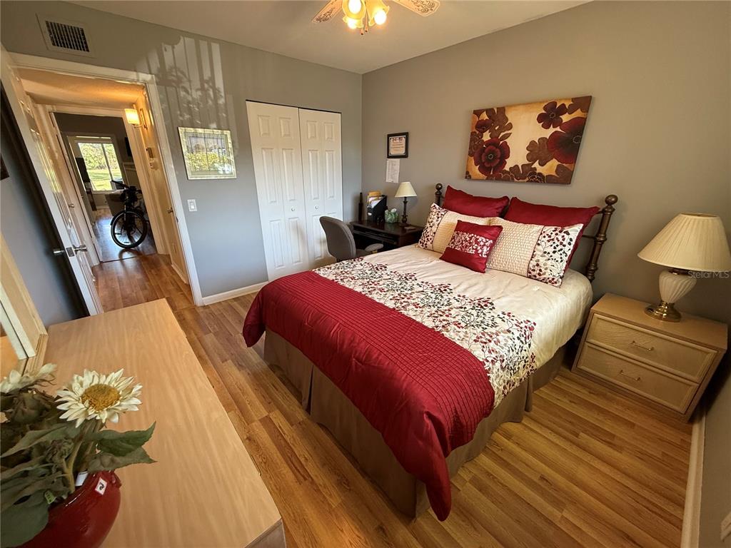 2460 Canadian Way, Unit 22 Clearwater, FL 33763 - Photo 27 of 42 a bedroom with a bed and a chandelier