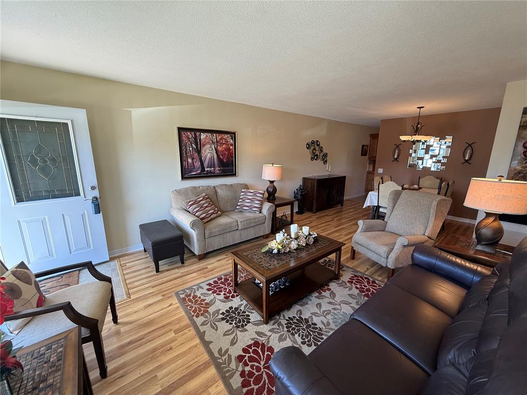 2460 Canadian Way, Unit 22 Clearwater, FL 33763 - Photo 5 of 42 a living room with furniture or couch and a wooden floor