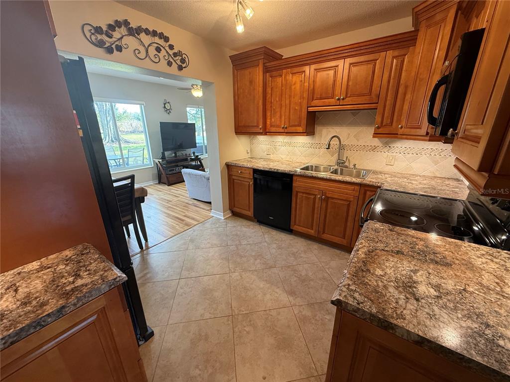 2460 Canadian Way, Unit 22 Clearwater, FL 33763 - Photo 9 of 42 a kitchen with granite countertop a sink stove and cabinets