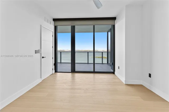 a view of an empty room with a cabinet