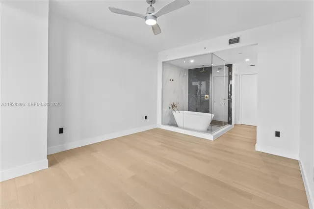 a bathroom with a granite countertop sink a bathtub and with shower