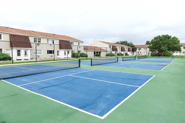 a view of swimming pool with outdoor seating and lake view