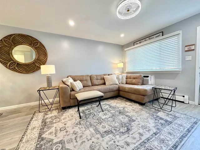 a kitchen with granite countertop a refrigerator and a stove top oven