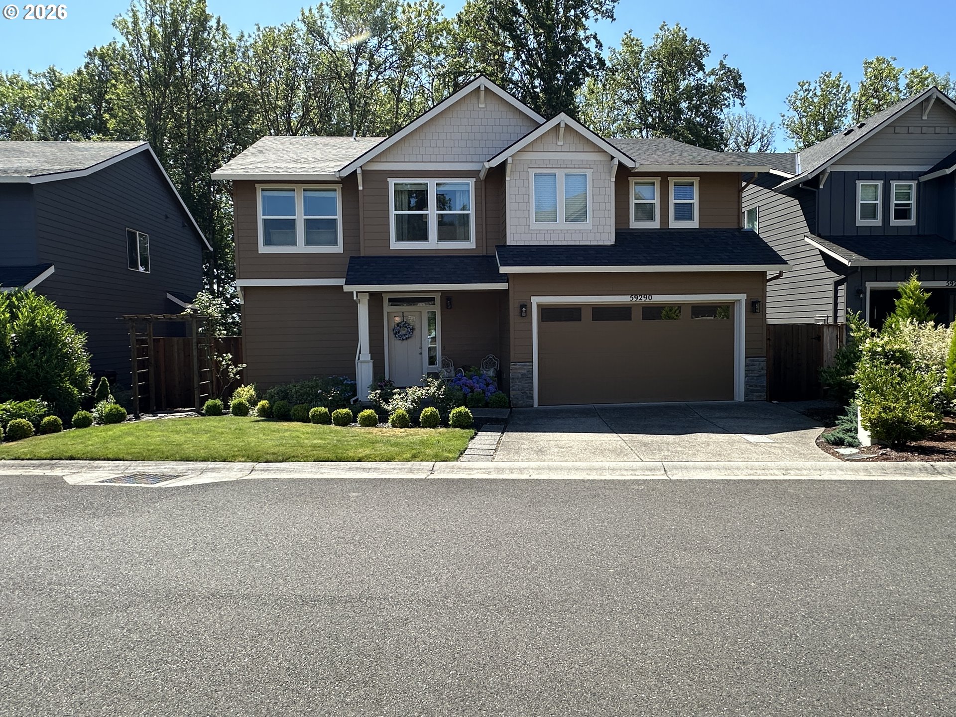 59290 Forest Trail Circle St. Helens, OR 97051 - Photo 1 of 33 a front view of a house with a yard and garage