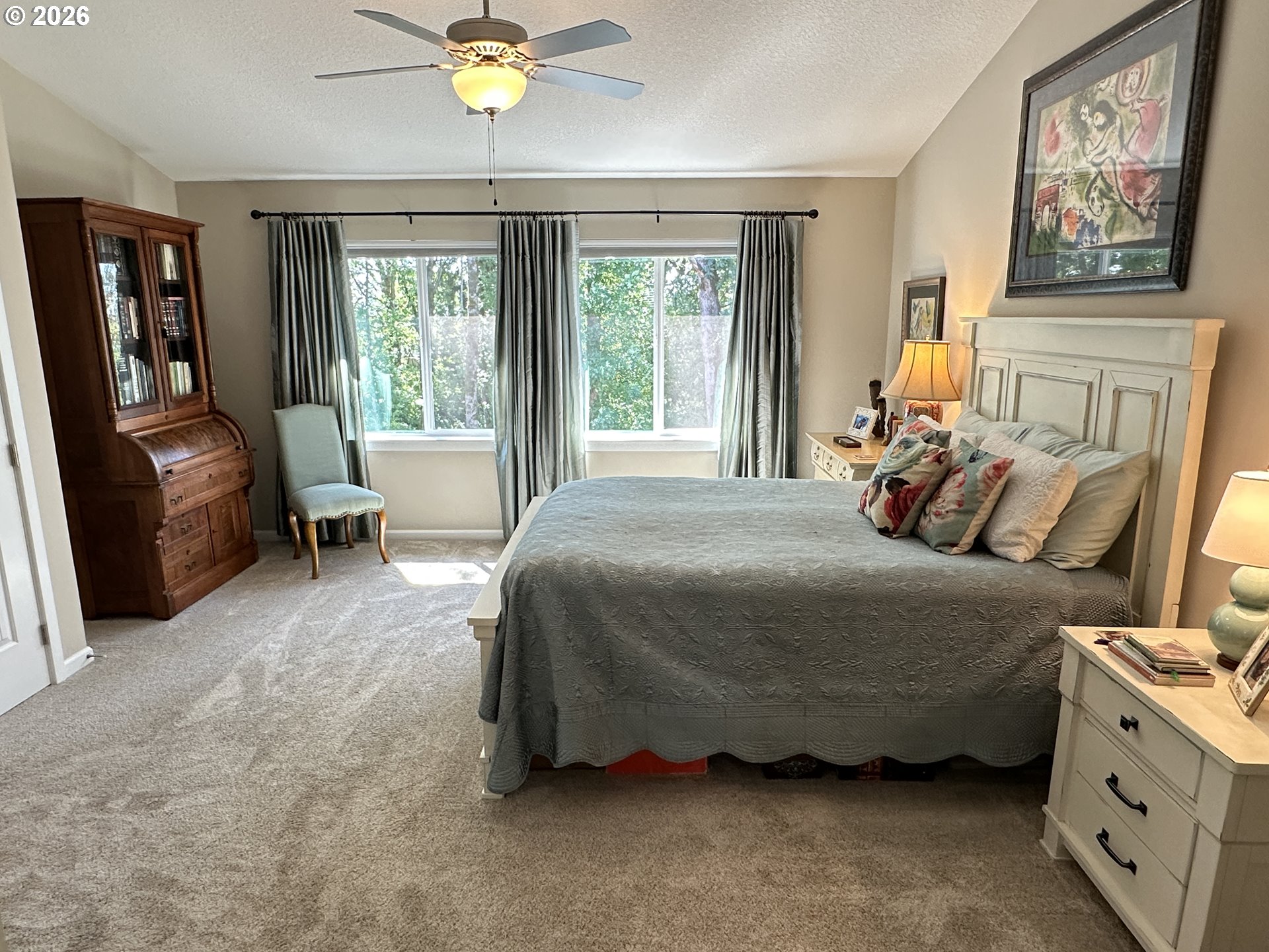 59290 Forest Trail Circle St. Helens, OR 97051 - Photo 18 of 33 a bedroom with a bed a couch and a window