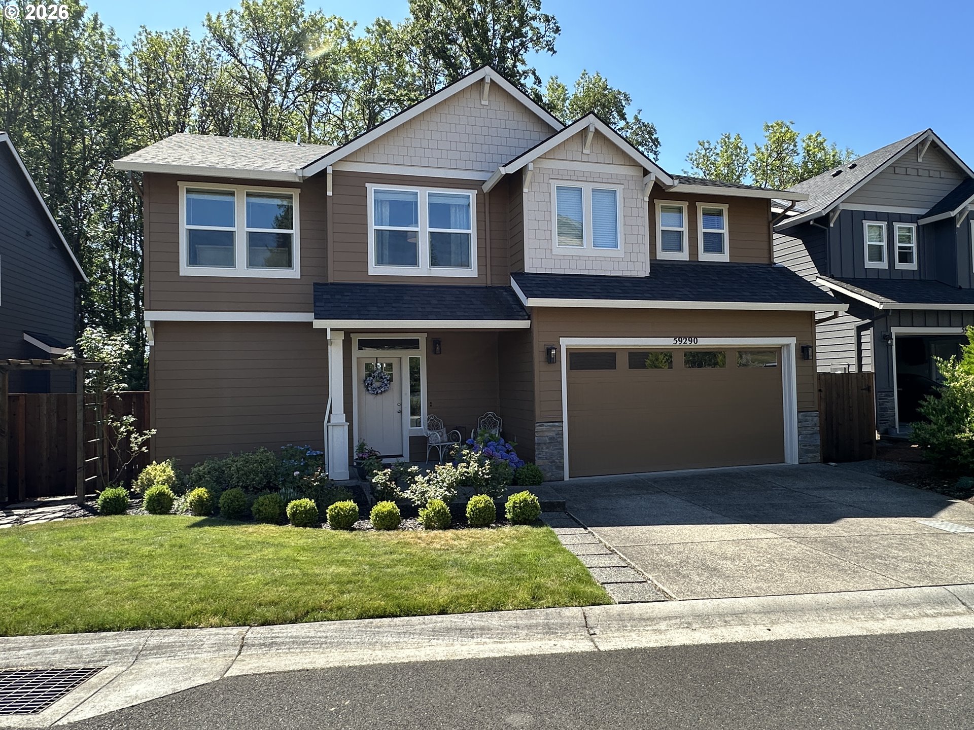59290 Forest Trail Circle St. Helens, OR 97051 - Photo 33 of 33 a front view of a house with a garden and plants