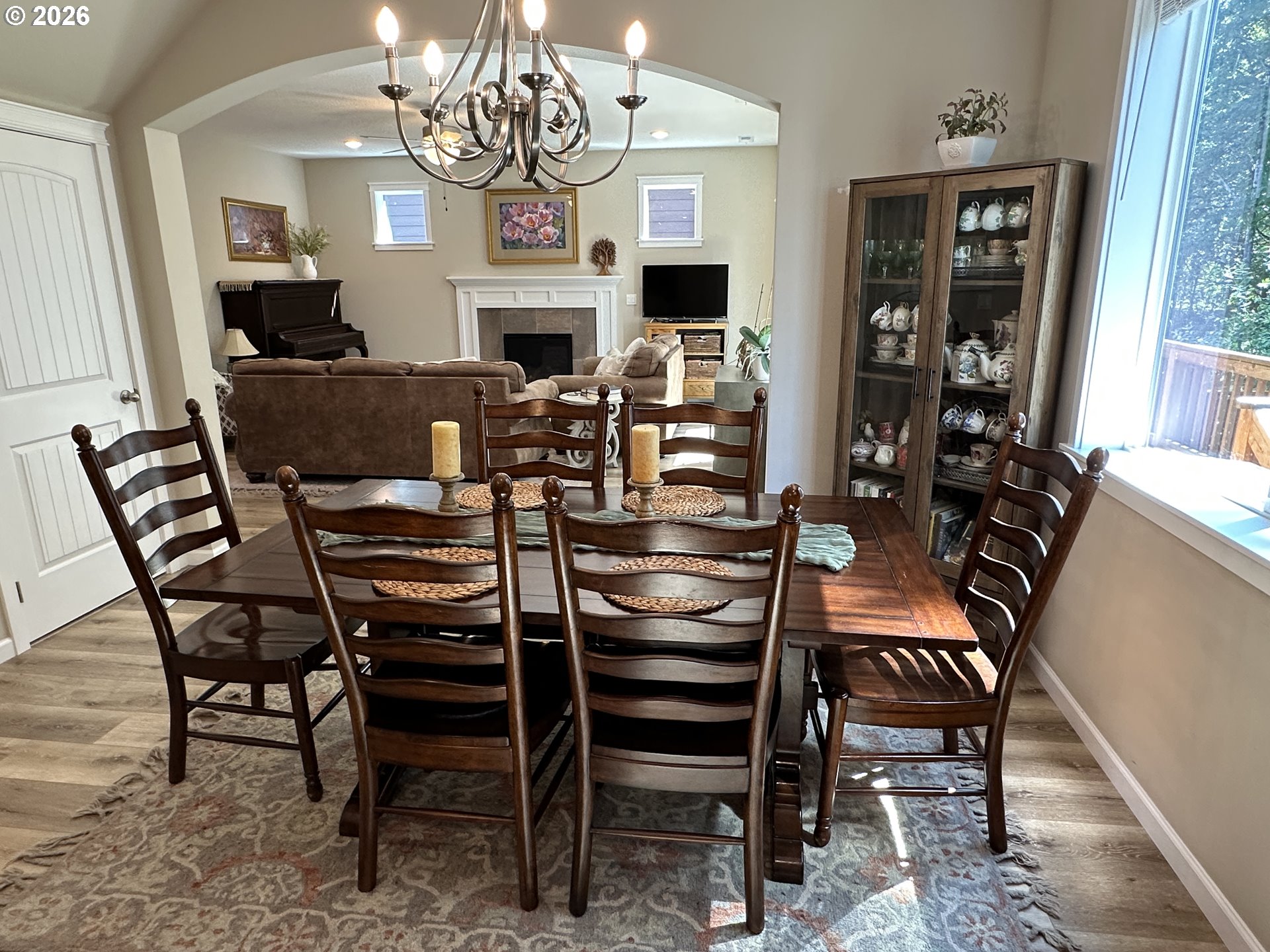 59290 Forest Trail Circle St. Helens, OR 97051 - Photo 8 of 33 a view of a dining room with furniture a chandelier and wooden floor