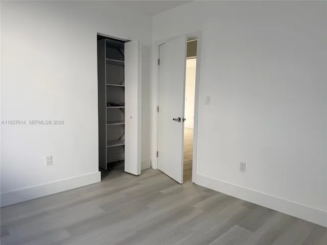 an empty room with wooden floor