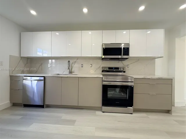 a kitchen with granite countertop a stove and a sink