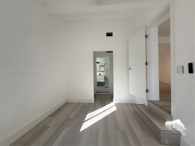 a view of hallway with wooden floor