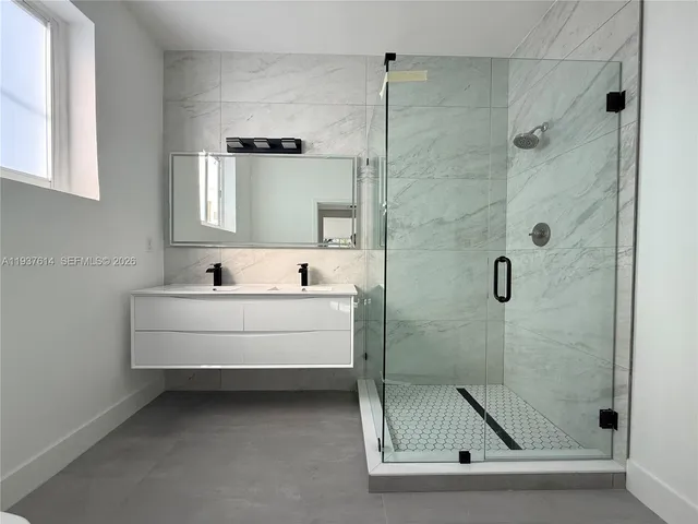 a bathroom with a bathtub and a shower