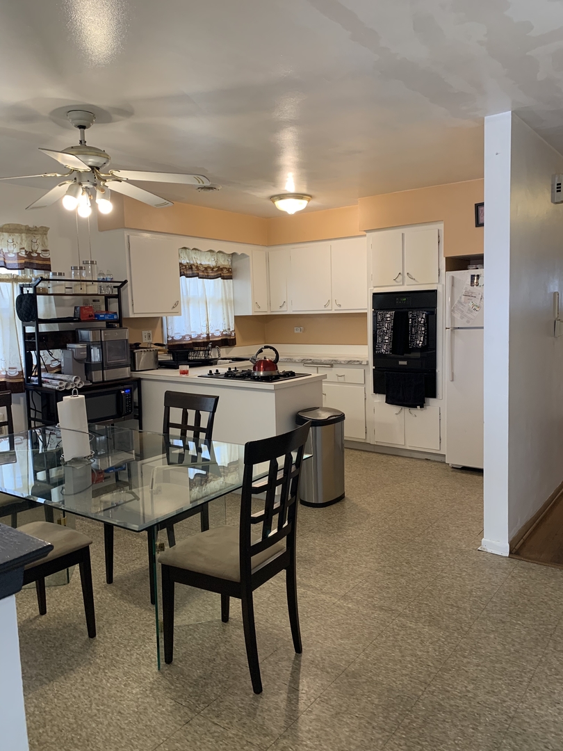 5706 St Charles Road Berkeley, IL 60163 - Photo 13 of 20 a kitchen with a table and chairs in it