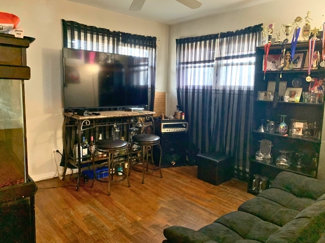 5706 St Charles Road Berkeley, IL 60163 - Photo 14 of 20 a living room filled with furniture and a flat screen tv