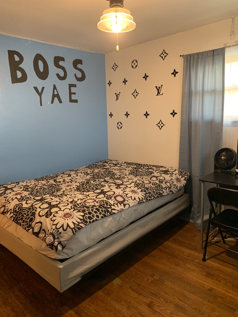 5706 St Charles Road Berkeley, IL 60163 - Photo 16 of 20 a bed sitting in a room next to a window