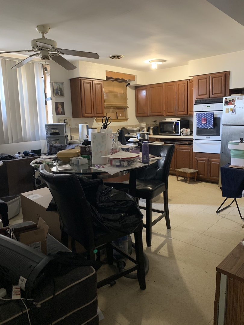5706 St Charles Road Berkeley, IL 60163 - Photo 7 of 20 a kitchen with a table and chairs in it