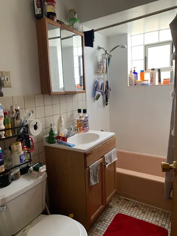 a bathroom with a sink toilet vanity and tub
