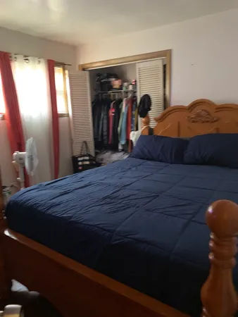 a bedroom with a bed and a closet