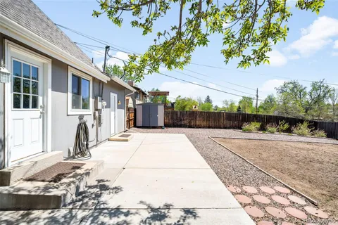 a view of a backyard with sitting area