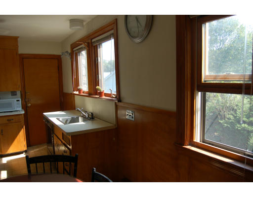 350 Langley Road Newton, MA 02459 - Photo 8 of 14 a bathroom with a sink a mirror and a window