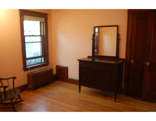 350 Langley Road Newton, MA 02459 - Photo 10 of 14 a room with a bed mirror and a window