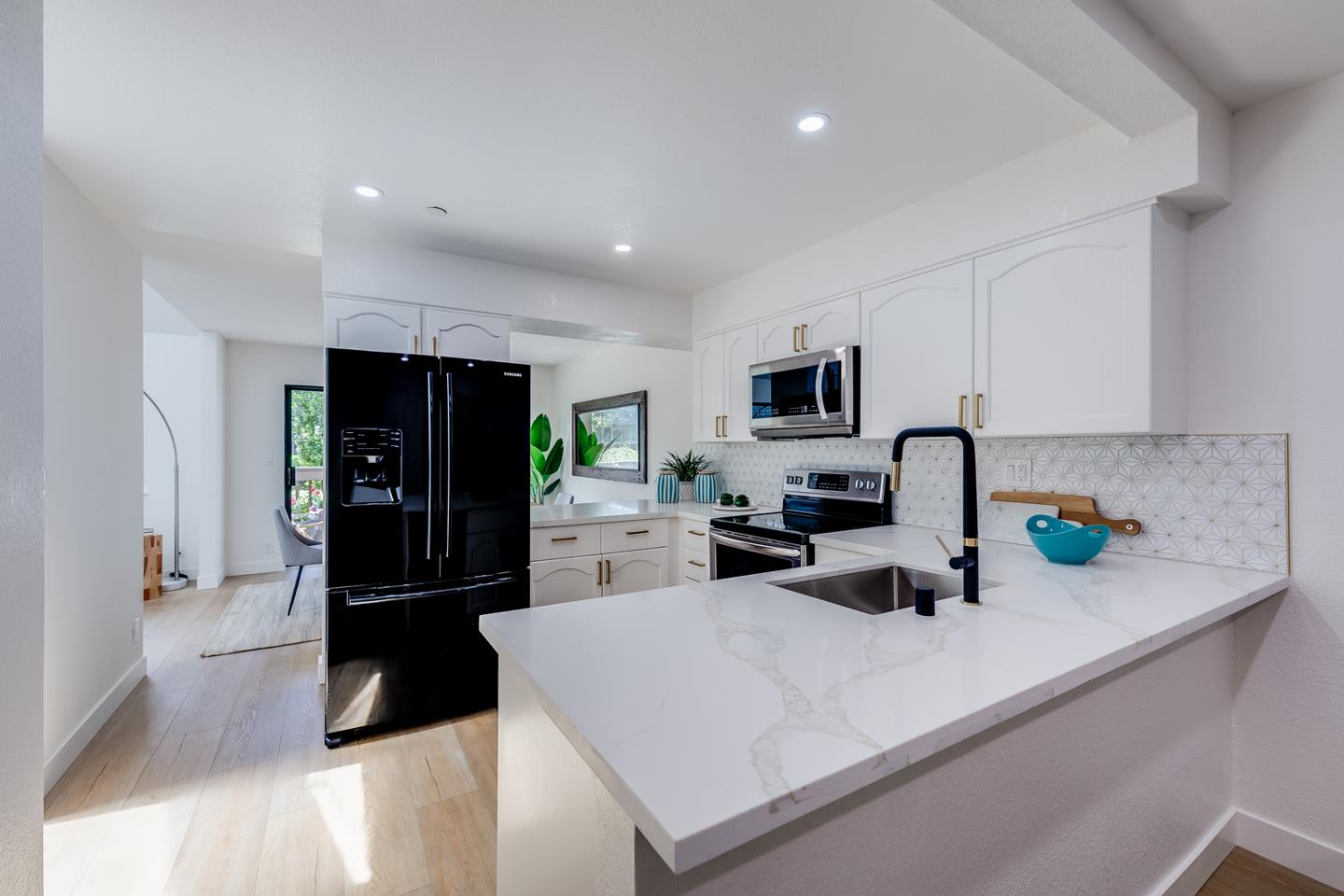 645 Sharp Park Road Pacifica, CA 94044 - Photo 13 of 34 a kitchen with a refrigerator a stove a microwave a sink and cabinets