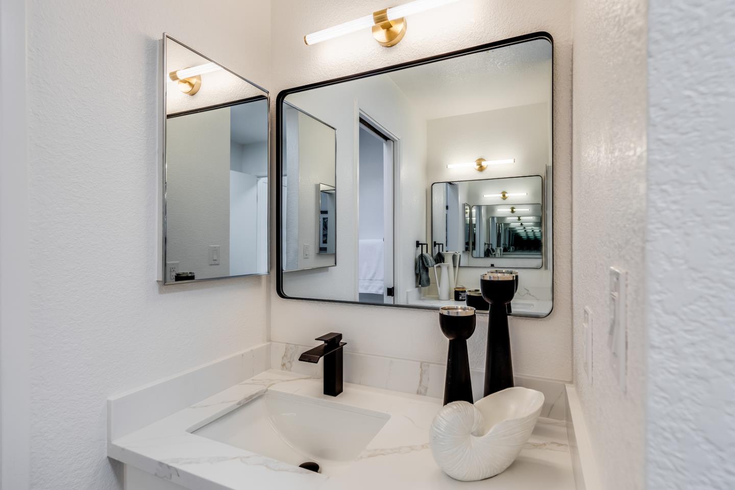 645 Sharp Park Road Pacifica, CA 94044 - Photo 18 of 34 a bathroom with a sink and mirror with toilet