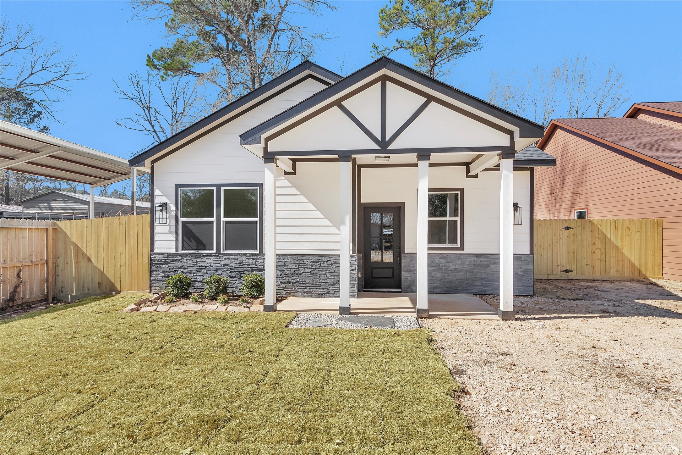 105 Canary St Point Point Blank, TX 77364 - Photo 1 of 29 a view of a house with wooden walls and floor to ceiling window