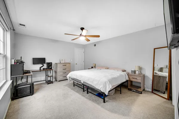 a spacious bedroom with a bed and furniture
