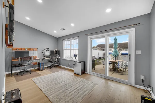 a living room with furniture and a wooden floor