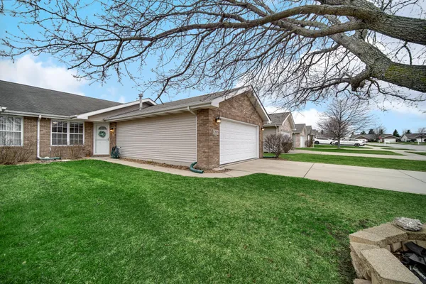 a front view of house with yard and green space