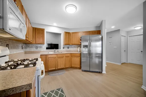 a kitchen with a refrigerator and a sink