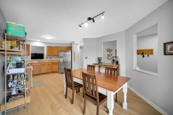 a view of a dining room with furniture and a kitchen