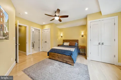 a spacious bedroom with a bed and a dresser