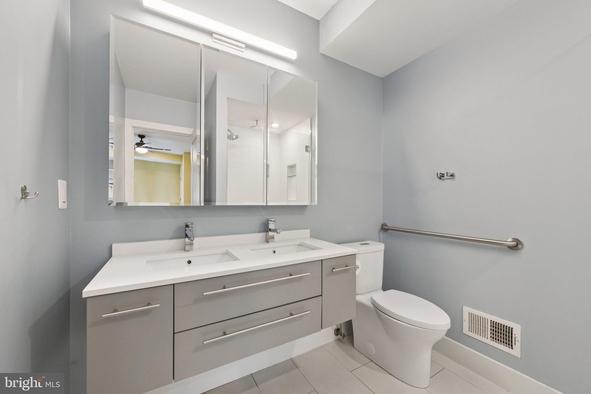 1301 Potomac Avenue Southeast, Unit 2 Washington, DC 20003 - Photo 21 of 27 a bathroom with a sink a toilet and a mirror